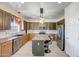 Modern kitchen with a granite island, stainless steel appliances, stylish pendant lighting, and ample cabinet space at 11936 W Alvarado Rd, Avondale, AZ 85392