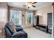 Relaxing living room with comfortable seating, ample natural light, and a ceiling fan for added comfort at 11936 W Alvarado Rd, Avondale, AZ 85392