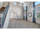 Open living area with high ceilings, wood-look tile flooring, large windows, and elegant lighting fixtures at 11936 W Alvarado Rd, Avondale, AZ 85392