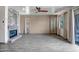 Spacious living room featuring a fireplace, wood-look tile flooring, and sliding door access to the patio at 11936 W Alvarado Rd, Avondale, AZ 85392