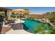Backyard pool and desert landscaping featuring a putting green and covered hot tub with seating areas at 11936 W Alvarado Rd, Avondale, AZ 85392