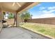 Backyard featuring a covered patio, grass, rock border, and block wall at 12089 N 145Th Dr, Surprise, AZ 85379