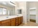 Bathroom featuring double sinks, walk in shower, and walk in closet at 12089 N 145Th Dr, Surprise, AZ 85379