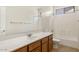Bright bathroom featuring a vanity with a solid surface counter, a large mirror, and a tub/shower combination at 12089 N 145Th Dr, Surprise, AZ 85379