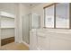 Bright bathroom with a walk-in shower, soaking tub, and walk-in closet at 12089 N 145Th Dr, Surprise, AZ 85379