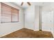 Bedroom features neutral carpet, a ceiling fan, a window with blinds, and a closet with sliding doors at 12089 N 145Th Dr, Surprise, AZ 85379