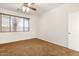 Bedroom with neutral walls, carpet flooring, ceiling fan, and window at 12089 N 145Th Dr, Surprise, AZ 85379