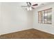 A basic bedroom with carpet, ceiling fan, window, and neutral paint at 12089 N 145Th Dr, Surprise, AZ 85379