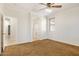 Bedroom showing walk-in bathroom, neutral walls, carpet flooring and a ceiling fan at 12089 N 145Th Dr, Surprise, AZ 85379