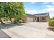 Single story home featuring solar panels, a two car garage, and desert landscaping at 12089 N 145Th Dr, Surprise, AZ 85379