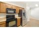 Modern kitchen boasts stainless steel refrigerator, black oven, and black microwave at 12089 N 145Th Dr, Surprise, AZ 85379
