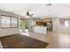 Spacious living room featuring sliding glass doors, an open kitchen with stainless steel appliances, and tile flooring at 12089 N 145Th Dr, Surprise, AZ 85379