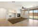 A neutral living room with a fireplace, tile flooring, and a sliding glass door at 12089 N 145Th Dr, Surprise, AZ 85379