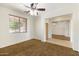 A bedroom with a view into the living room, featuring carpet and tile flooring at 12089 N 145Th Dr, Surprise, AZ 85379