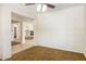 A living room with carpet, tile, and fireplace that leads into other rooms at 12089 N 145Th Dr, Surprise, AZ 85379