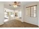 A spacious living room with multiple entry points to different rooms in the home at 12089 N 145Th Dr, Surprise, AZ 85379