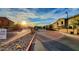 Gated community entrance with beautiful sunlit sky, brick paved streets and desert landscaping at 1350 S Greenfield Rd # 2231, Mesa, AZ 85206