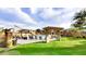 Community pool with lounge chairs, covered seating areas, and lush green grass at 1350 S Greenfield Rd # 2231, Mesa, AZ 85206
