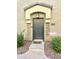 Charming front door enhanced by stone accents and manicured landscaping, creating an inviting curb appeal at 1350 S Greenfield Rd # 2231, Mesa, AZ 85206