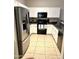 Clean kitchen features stainless appliances and tile flooring at 1350 S Greenfield Rd # 2231, Mesa, AZ 85206