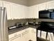 Bright kitchen featuring white cabinets and modern appliances at 1350 S Greenfield Rd # 2231, Mesa, AZ 85206