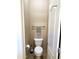 Compact toilet room with a standard toilet, towel rack, and toilet paper holder, maximizing space efficiency at 1350 S Greenfield Rd # 2231, Mesa, AZ 85206