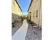Charming walkway lined with decorative rock leading to a wooden fence and lush greenery at 1350 S Greenfield Rd # 2231, Mesa, AZ 85206