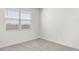 Corner view of a bedroom with a window and neutral colored carpet at 1375 S 239Th Dr, Buckeye, AZ 85326