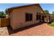 Exterior view of house with desert landscaping with stone and small patch of artifical turf in a private backyard at 14314 W Lexington Ave, Goodyear, AZ 85395
