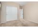 This bedroom shows a closet with light, neutral walls and carpeting at 14314 W Lexington Ave, Goodyear, AZ 85395