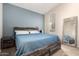 This bedroom features a wooden bed frame and a ensuite bathroom view at 14314 W Lexington Ave, Goodyear, AZ 85395
