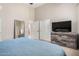 The primary bedroom shows a TV and dresser with light, neutral walls at 14314 W Lexington Ave, Goodyear, AZ 85395