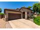 Charming single-Gathering home with a well-maintained front yard and a two-car garage on a sunny day at 14314 W Lexington Ave, Goodyear, AZ 85395