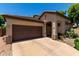 Charming single-story home with a well-maintained front yard, inviting curb appeal, and an attached two-car garage at 14314 W Lexington Ave, Goodyear, AZ 85395