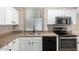 Kitchen with stainless steel appliances, granite countertops, tile backsplash and white cabinets at 14314 W Lexington Ave, Goodyear, AZ 85395