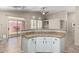 Kitchen with granite countertops, white cabinets, stainless appliances, and tile flooring open to the Gathering room at 14314 W Lexington Ave, Goodyear, AZ 85395