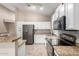 Modern kitchen showcasing stainless steel appliances, granite countertops, tile backsplash, and white cabinetry at 14314 W Lexington Ave, Goodyear, AZ 85395