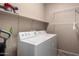 A laundry room featuring a washer and dryer with overhead storage at 14314 W Lexington Ave, Goodyear, AZ 85395