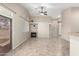 Spacious living room featuring a fireplace, tile flooring, and bright natural light with access to the backyard at 14314 W Lexington Ave, Goodyear, AZ 85395