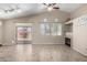 Bright living room showcasing a fireplace, tile floors, with access to the back yard at 14314 W Lexington Ave, Goodyear, AZ 85395