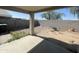 A backyard space with a covered patio, block fencing, and desert landscaping at 14700 N El Frio St, El Mirage, AZ 85335