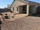 Low-maintenance backyard with gravel landscaping and a covered patio at 14700 N El Frio St, El Mirage, AZ 85335