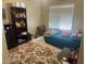 Cozy bedroom with a plush carpet, comfortable bed, and ample storage space from the shelves at 14700 N El Frio St, El Mirage, AZ 85335