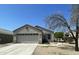 Charming single-story home with a two car garage and a well-maintained front yard at 14700 N El Frio St, El Mirage, AZ 85335
