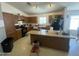 Inviting kitchen featuring wood cabinetry, a large island, and plenty of counter space at 14700 N El Frio St, El Mirage, AZ 85335