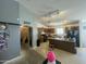 Spacious kitchen with wood cabinets and an island, adjacent to a living area at 14700 N El Frio St, El Mirage, AZ 85335