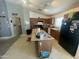 View of the kitchen with wood cabinets, a large island, and a black refrigerator at 14700 N El Frio St, El Mirage, AZ 85335