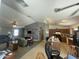 Open-concept living room seamlessly connects to the kitchen with track lighting and vaulted ceilings at 14700 N El Frio St, El Mirage, AZ 85335