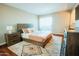 Bright bedroom with a large bed, decorative rug, and wood-style furniture at 1645 W Baseline Rd # 2026, Mesa, AZ 85202