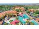 Aerial view of a community pool area featuring pools, lounge areas, and meticulously manicured landscaping at 16961 W Holly St, Goodyear, AZ 85395